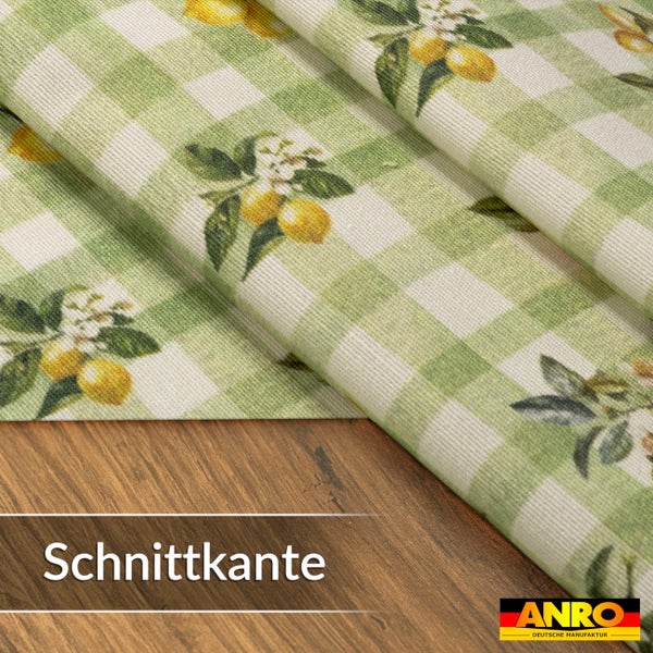 Wachstuch mit grün-weißem Karomuster, Zitronenmotiv und Schnittkante. ANRO Logo.