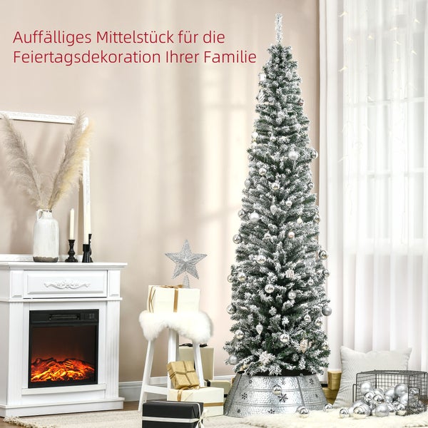 Schlanker künstlicher Weihnachtsbaum mit Schneeeffekt und silbernen Kugeln neben einem weißen elektrischen Kamin in einem hellen Wohnzimmer.