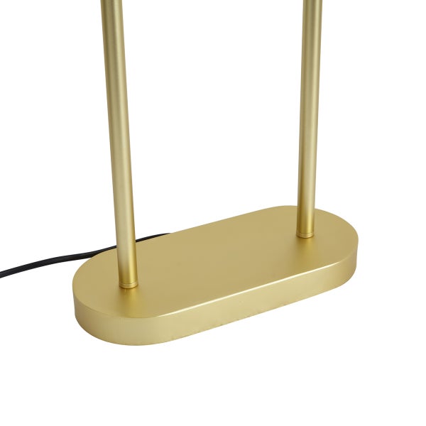 Nahaufnahme eines ovalen Lampenfußes mit zwei Stangen aus goldfarbenem Metall und einem schwarzen Kabel.