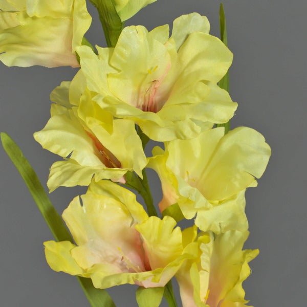 Künstliche Gladiole Gelb mit Blüten und grünen Blättern.