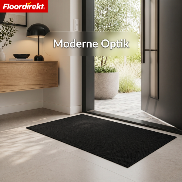 Schwarze Schmutzfangmatte vor einer offenen Tür in einem hellen modernen Flur mit Floordirekt Logo und Text Moderne Optik.
