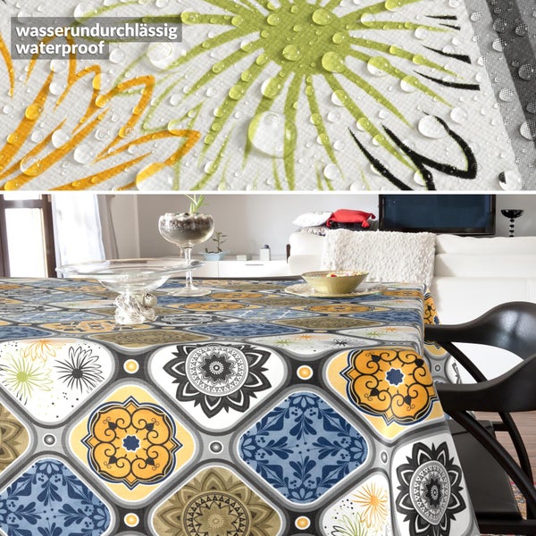 Wasserundurchlässige Tischdecke mit farbenfrohem, geometrischem Muster in einem Wohnzimmer; Detailansicht zeigt abperlende Wassertropfen.