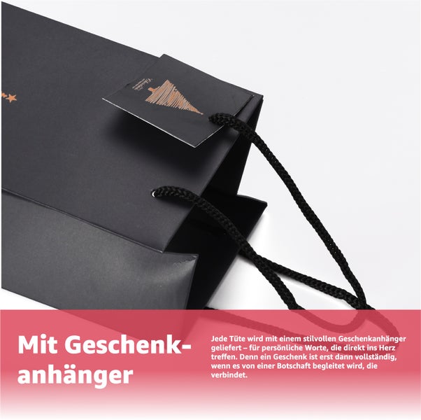 Schwarze Geschenktasche mit Geschenkanhänger und Kordelgriffen