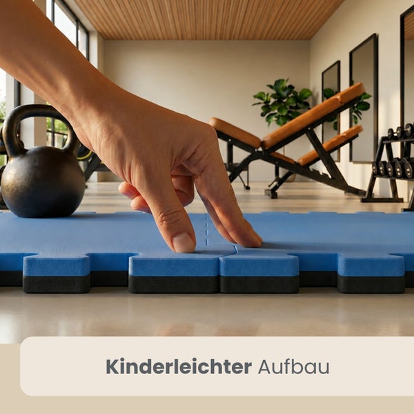 Hand setzt ineinandergreifende Fitnessmatten im Puzzledesign in einem hellen Fitnessraum mit Trainingsgeräten zusammen.