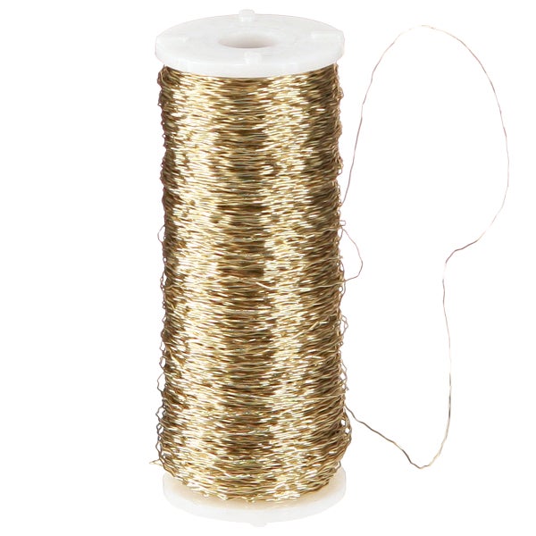 Goldener Wickeldraht auf einer weißen Kunststoffspule für Bastelarbeiten.
