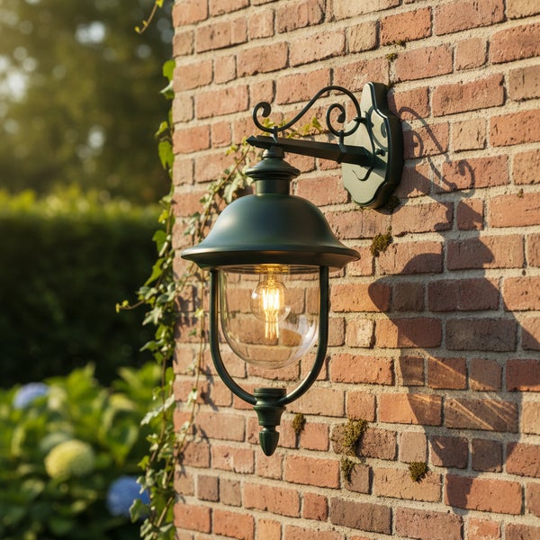 Klassische Außenwandleuchte aus Metall mit klarem Glas montiert an einer Ziegelwand.