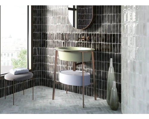 Badezimmer mit Waschbecken, Spiegel, Hocker und Fliesen