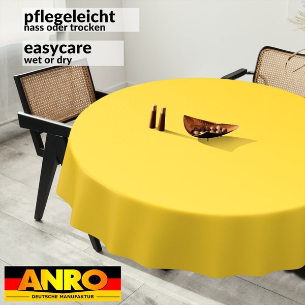 Runde gelbe Tischdecke auf einem Esstisch, pflegeleicht nass oder trocken abwischbar, ANRO Logo.