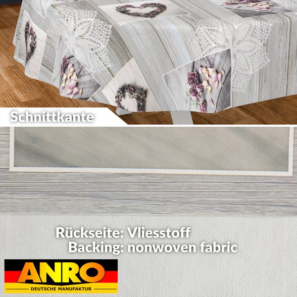 Wachstuch-Tischdecke mit Holzoptik und Blumenmotiven. Detailansicht der Schnittkante und der Rückseite aus Vliesstoff. ANRO Logo.