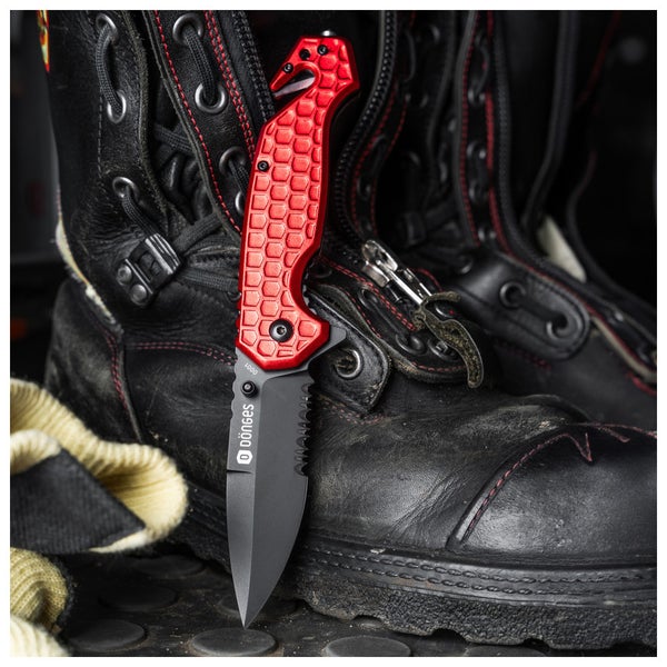Dönges Rettungsmesser mit Wellenschliff, Gurtschneider und Glasbrecher, angelehnt an schwarze Sicherheitsstiefel aus Leder mit roten Nähten.
