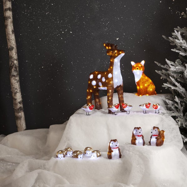 Dekorative Szene mit leuchtenden Tierfiguren: Reh, Fuchs, Rotkehlchen, Eichhörnchen und Igel.