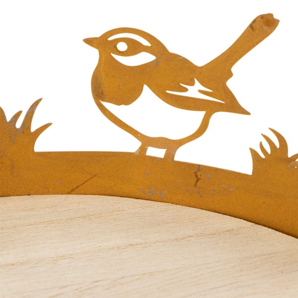 Metalldekoration mit Vogel-Silhouette in Edelrost-Optik auf Holz.