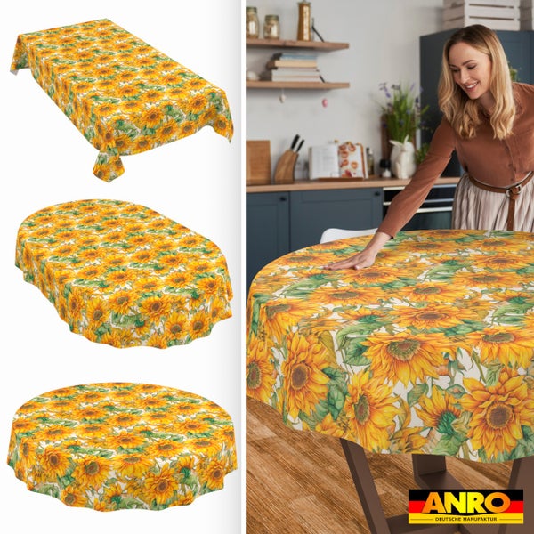 Tischdecken mit Sonnenblumenmuster in rechteckiger, ovaler und runder Form, in heller Küche auf Esstisch, ANRO DEUTSCHE MANUFAKTUR Logo.