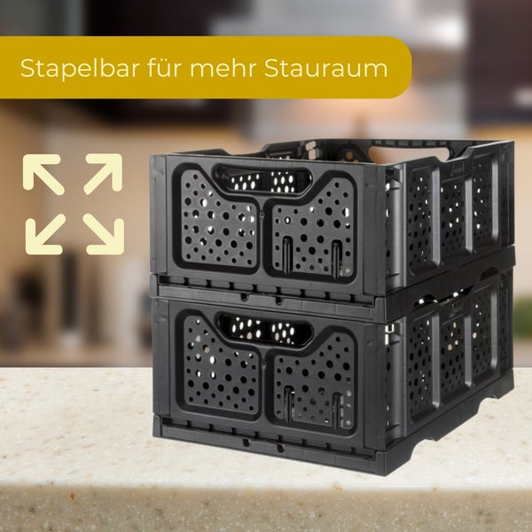 Zwei stapelbare schwarze Klappboxen aus Kunststoff für zusätzlichen Stauraum.
