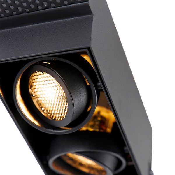 Nahaufnahme eines schwarzen verstellbaren LED-Strahlers mit warmem Licht und strukturierter Linse.