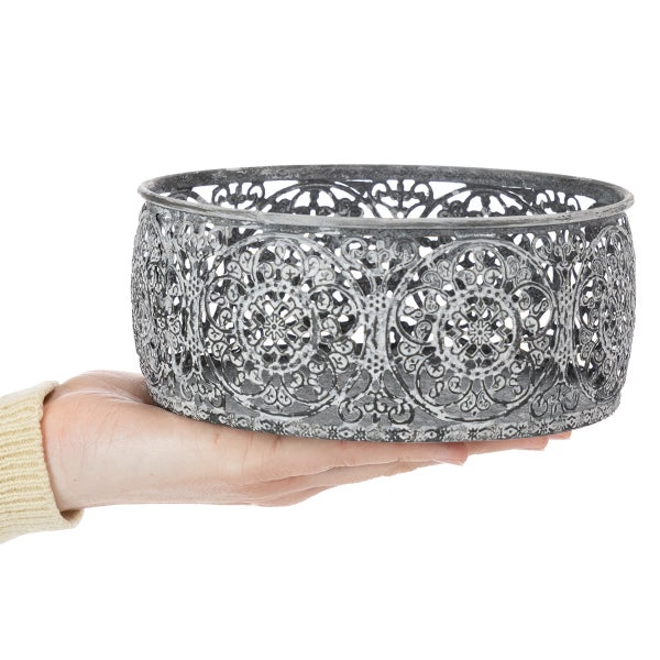 Dekorative graue Metallschale mit filigranem Ornamentmuster in einer Hand gehalten.