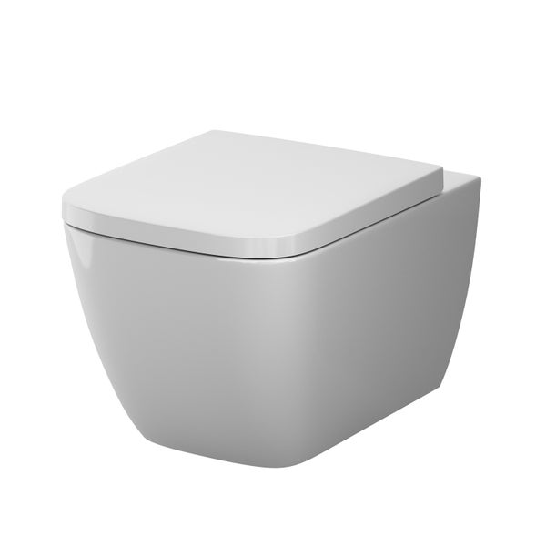 Weiße wandhängende Toilette aus Keramik mit passendem Toilettensitz in eckiger Form.