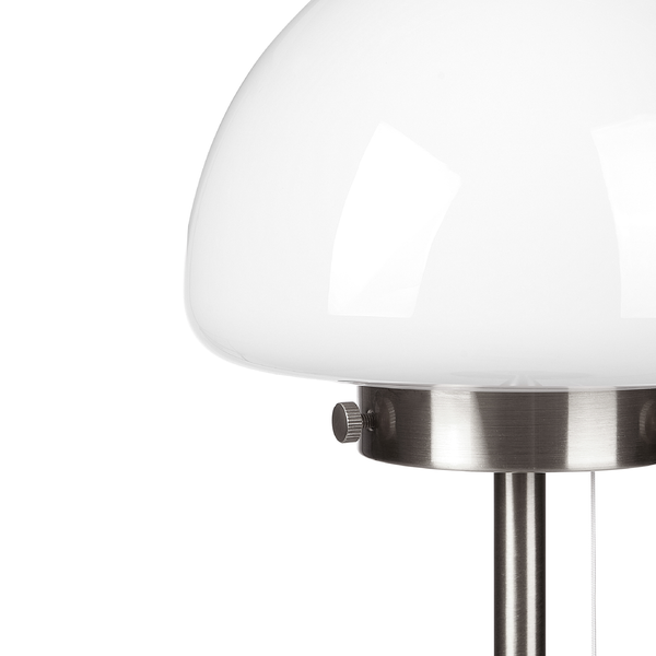 Nahaufnahme einer Lampe mit weißem Glasschirm und Ständer aus gebürstetem Metall mit Zugschalter.