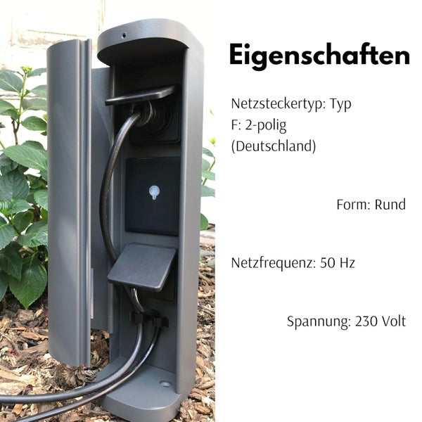 Runde Außensteckdosensäule im Garten mit zwei Steckdosen Typ F, 2-polig, 50 Hertz, 230 Volt, graues Gehäuse mit eingesteckten Kabeln.