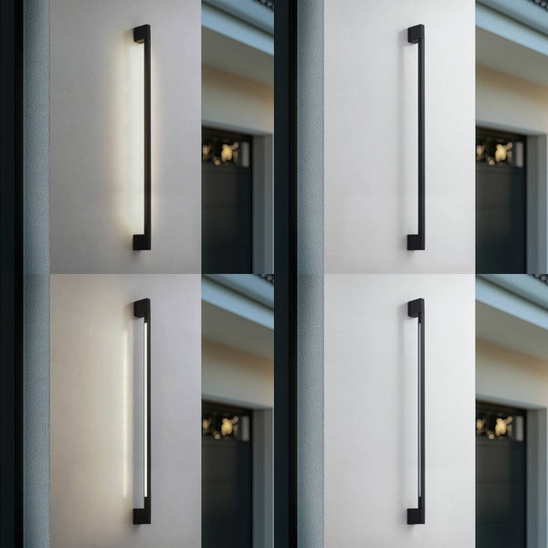Schwarze, stabförmige LED-Außenwandleuchte montiert an einer Hauswand, zeigt indirektes warmweißes Licht.