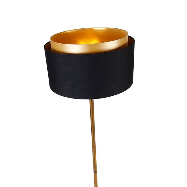 Stehleuchte mit schwarzem Lampenschirm und goldenem Akzent