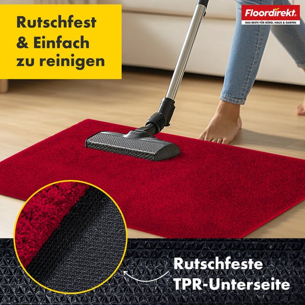 Roter Teppich wird mit Staubsauger gereinigt, Detailaufnahme der rutschfesten TPR Unterseite