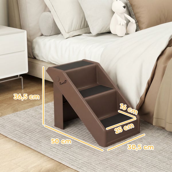 Hundetreppe aus Kunststoff mit 3 Stufen, Antirutschbelag, Maße 50 mal 30,5 mal 36,5 Zentimeter, PawHut Logo, neben einem Bett platziert.