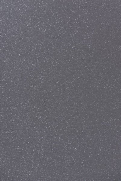 Nahaufnahme einer gesprenkelten Oberfläche in Steinoptik mit feinen hellen Punkten.