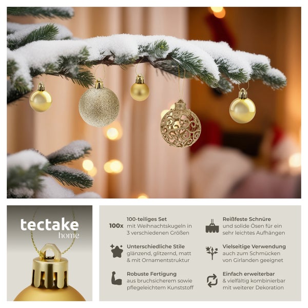 Goldene Weihnachtskugeln von tectake home auf einem schneebedeckten Ast