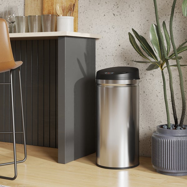 Szene mit einer Person an einem Schreibtisch mit einer Lampe, Stiften, einem Holzmodell und einer Heizung