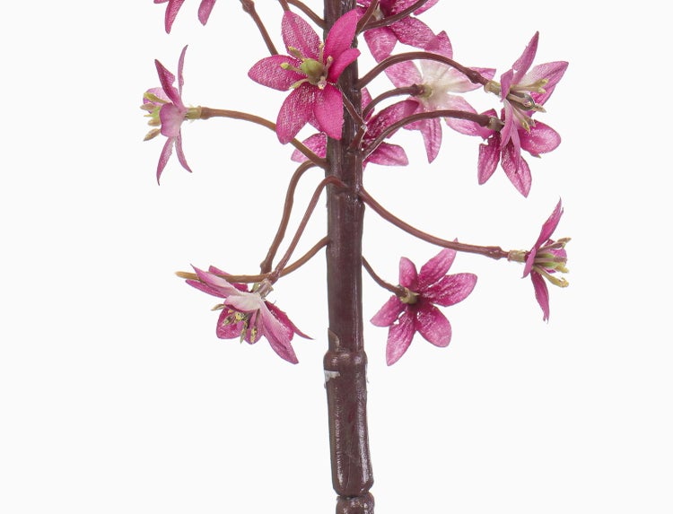 Künstlicher Blütenzweig mit pinken, sternförmigen Blüten an einem braunen Stängel.