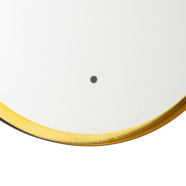 Detailansicht eines runden Spiegels mit goldenem Rahmen