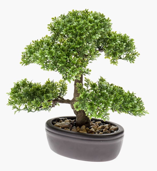 Künstlicher Bonsai-Baum in einer ovalen Schale mit dekorativen Steinen.
