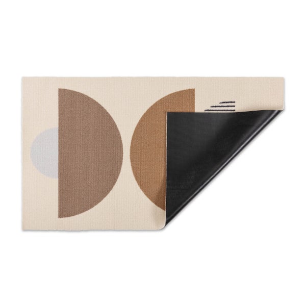 Moderne Türmatte mit geometrischem Muster aus Halbkreisen und Linien sowie rutschhemmender Rückseite an der umgeklappten Ecke.
