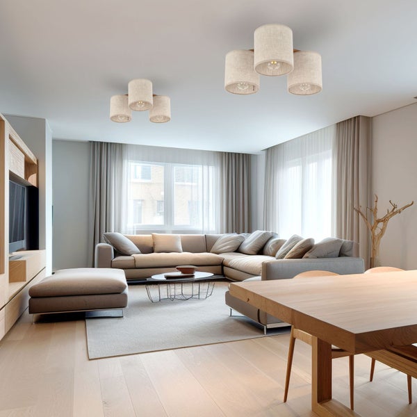 Wohnzimmer mit Ecksofa, Holztisch und zwei Deckenleuchten mit Stoffschirmen