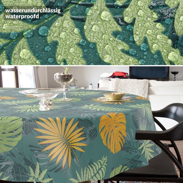 Runde wasserundurchlässige Tischdecke mit tropischem Blattmuster aus Monstera und Palmenblättern in einem modernen Wohnzimmer.