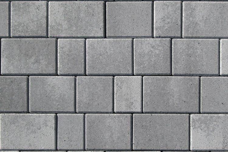 Pflastersteine aus Beton in verschiedenen rechteckigen und quadratischen Formaten, verlegt im Muster.