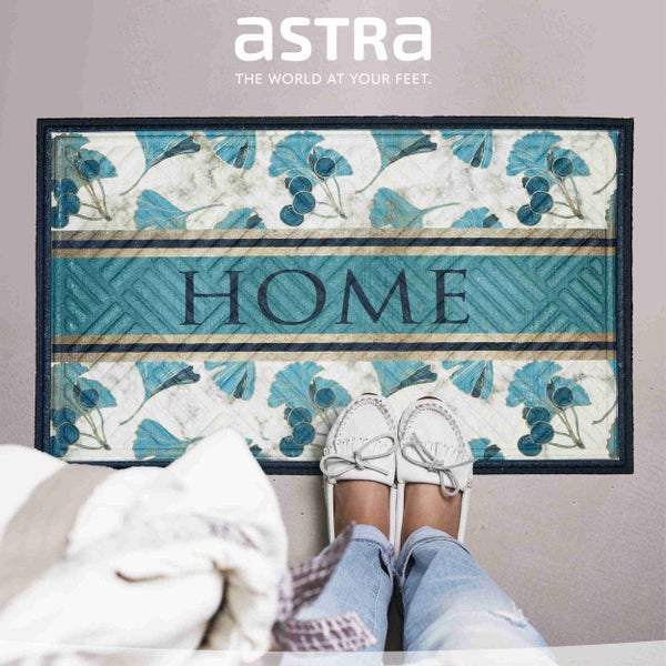 Fußabtreter mit Blattmuster und dem Schriftzug Zuhause.