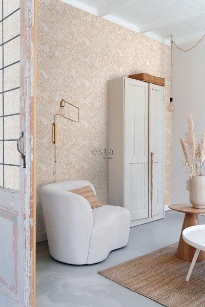 Wohnraum mit gemusterter Tapete, Sessel und Schrank