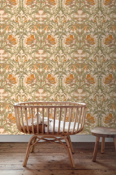 Raumansicht mit einer floralen Tapete, einem Kinderbett aus Rattan und einem kleinen Hocker.