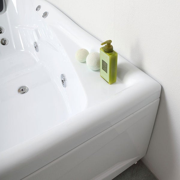 Detailansicht einer weißen Badewanne mit Massagedüsen und Badeprodukten