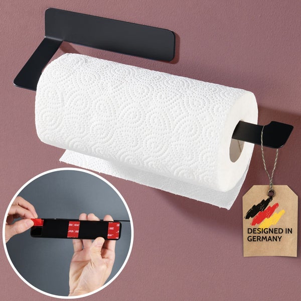 Schwarzer Handtuchhalter wird ohne Bohren an die Wand geklebt. Detailansicht zeigt das Auftragen von Kleber auf die Rückseite. Dekazia Logo.