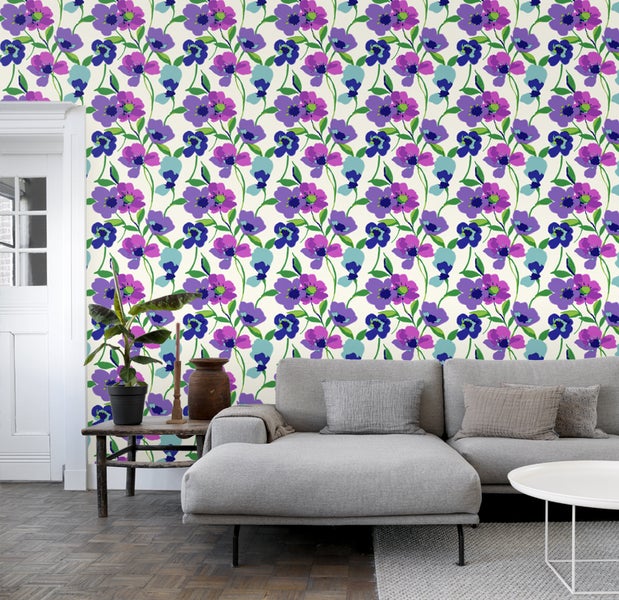 Wohnzimmer mit floral gemusterter Tapete, Sofa und Zimmerpflanze