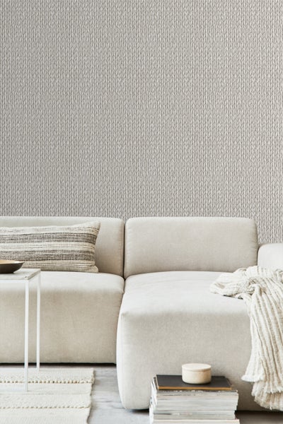 Wohnzimmer mit Strickmuster-Tapete, Sofa, Kissen und Beistelltisch für ein gemütliches Ambiente.