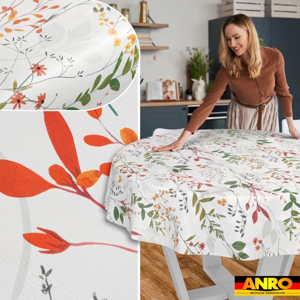 Runde, abwischbare Tischdecke mit floralem Muster aus Blättern und Blüten in einer Küche. ANRO Logo.