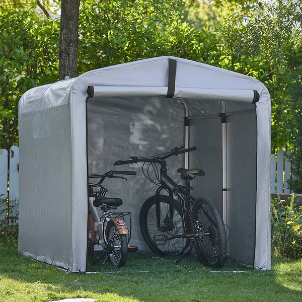 Fahrradgarage aus Gewebe mit zwei Fahrrädern im Garten.