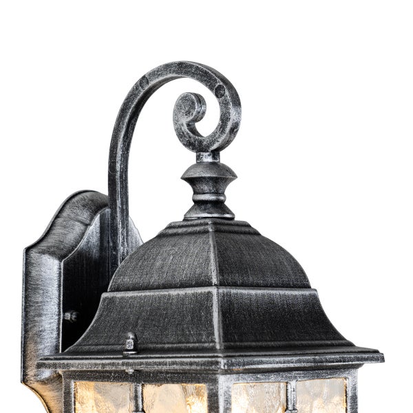 Außenwandleuchte aus Metall in Antik-Silber mit strukturiertem Glas und geschwungenem Wandarm.