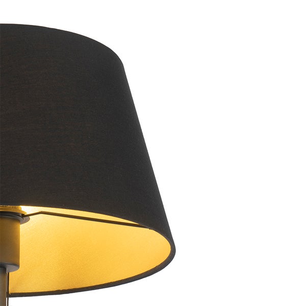 Lampenschirm aus schwarzem Textil mit goldfarbener Innenseite