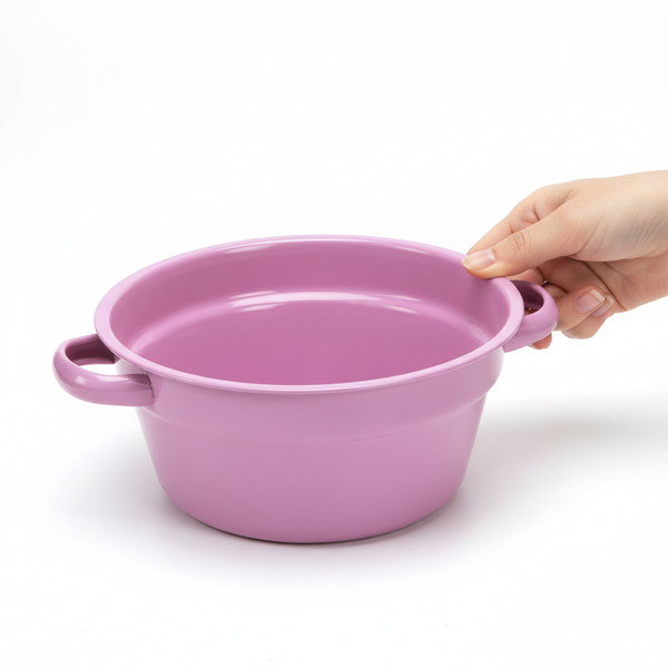 Rosa Schüssel mit zwei Griffen, von einer Hand gehalten.