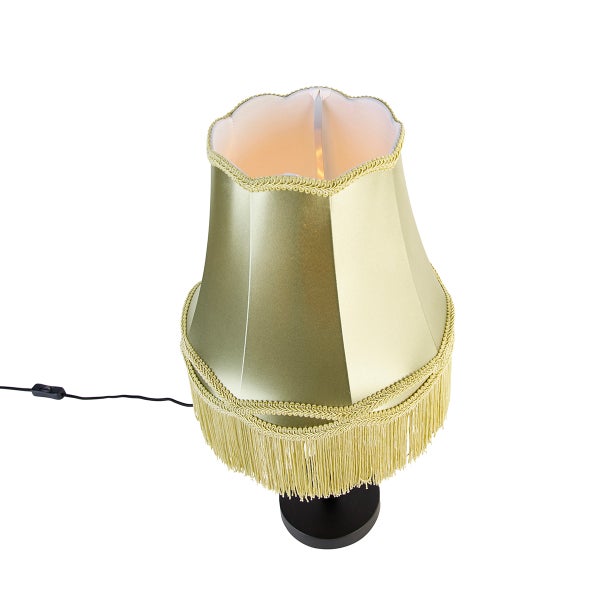 Klassische Tischleuchte mit goldfarbenem Stoffschirm, Fransen und schwarzem Fuß.